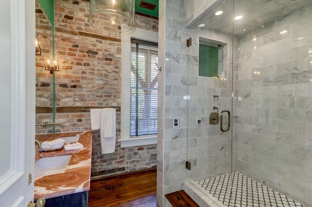bathroom featuring vanity, a shower with shower door, and hardwood / wood-style floors