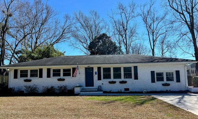 single story home with a front yard, brick siding, and crawl space