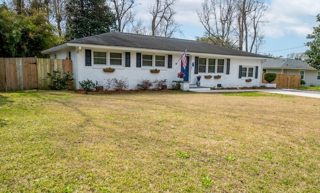 single story home featuring a front yard, fence, and brick siding