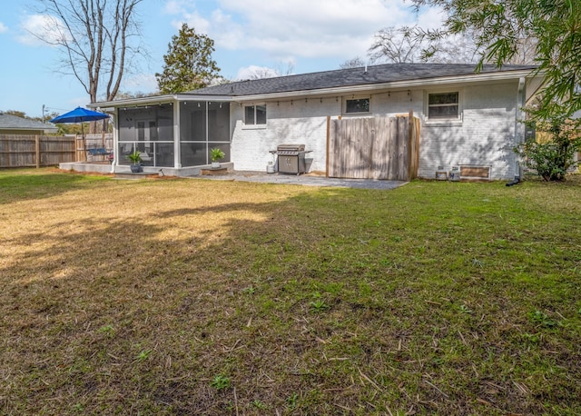 2137 Barbour Dr, Charleston, SC 29414 - rear view of house with brick siding, a sunroom, a yard, and fence