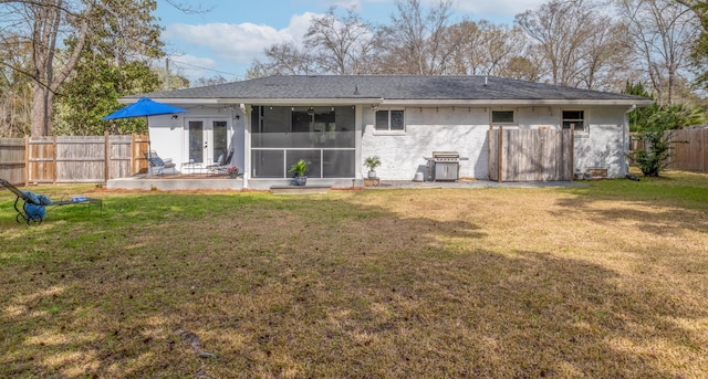 2137 Barbour Dr, Charleston, SC 29414 - back of property with a fenced backyard, french doors, a yard, a sunroom, and brick siding