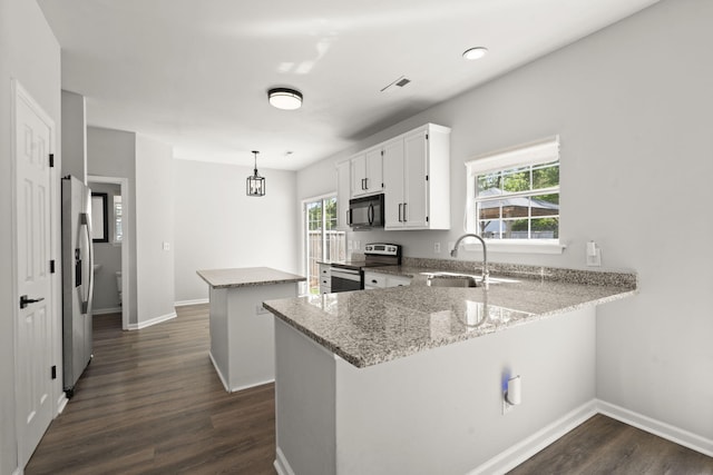 132 E Hartwick Ln, Goose Creek, SC 29445 - kitchen featuring dark wood-style flooring, a peninsula, a kitchen island, a sink, and stainless steel appliances