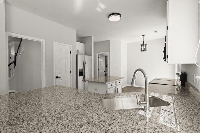 132 E Hartwick Ln, Goose Creek, SC 29445 - kitchen with stainless steel refrigerator with ice dispenser, range, a sink, light stone counters, and white cabinetry