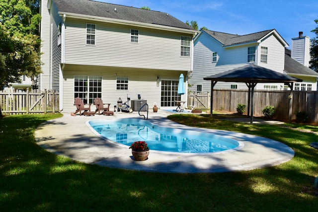 rear view of house with a patio, central AC unit, a fenced backyard, and a gate