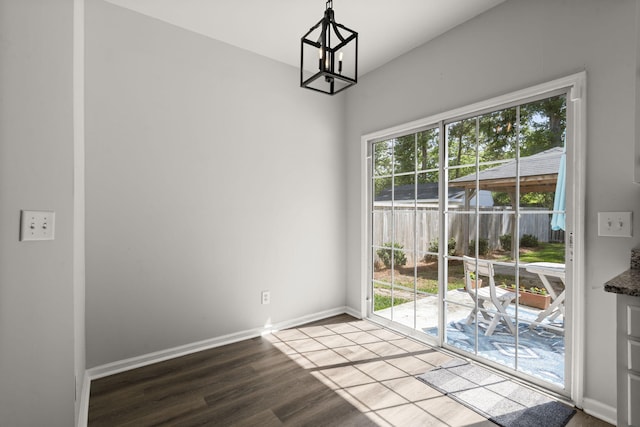 132 E Hartwick Ln, Goose Creek, SC 29445 - unfurnished dining area with baseboards, wood finished floors, and a notable chandelier