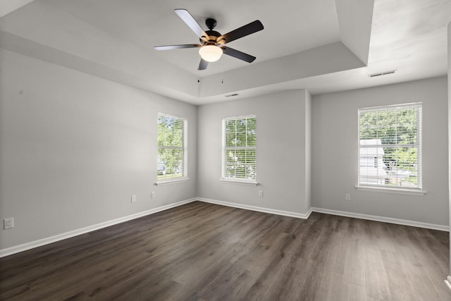 132 E Hartwick Ln, Goose Creek, SC 29445 - empty room featuring visible vents, baseboards, ceiling fan, dark wood-type flooring, and a raised ceiling