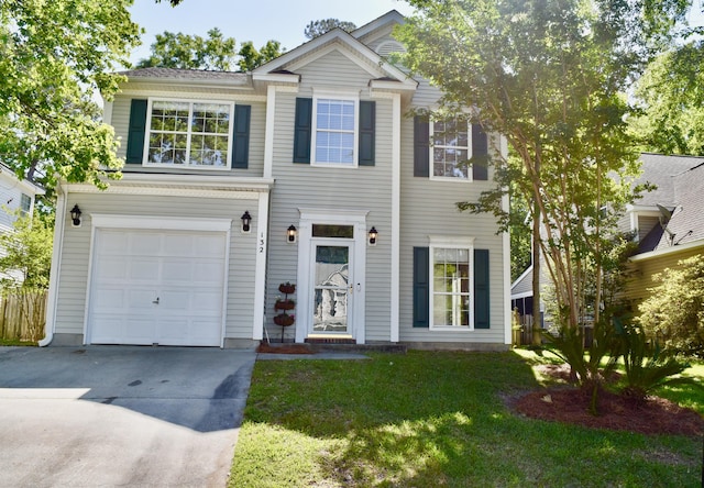 traditional home featuring an attached garage, a front lawn, and concrete driveway