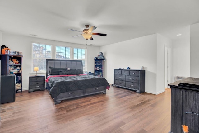 bedroom with ceiling fan and light hardwood / wood-style flooring