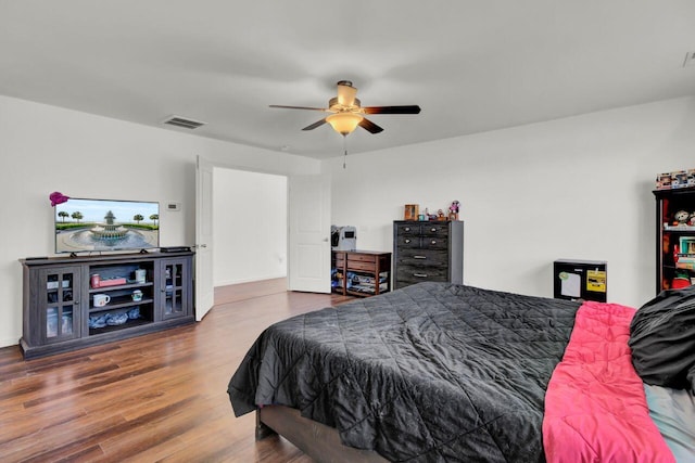 bedroom with ceiling fan and dark hardwood / wood-style floors