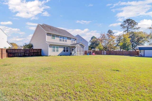 rear view of house with a lawn