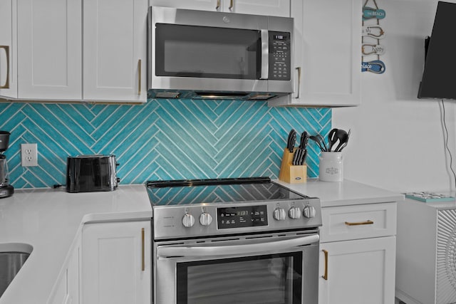 kitchen with white cabinetry, appliances with stainless steel finishes, decorative backsplash, and light countertops