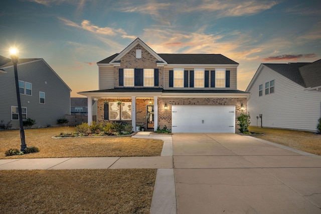 craftsman house with a garage and a lawn