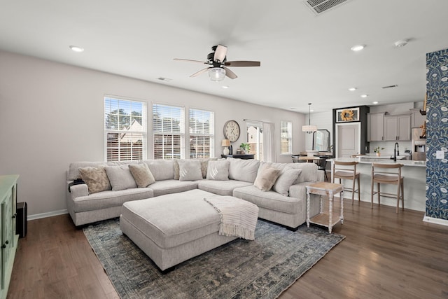 living room with ceiling fan, dark hardwood / wood-style flooring, and sink