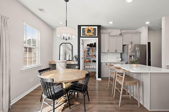 dining space with dark hardwood / wood-style floors