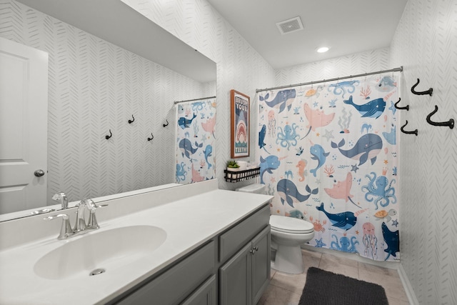 bathroom with tile patterned floors, vanity, and toilet