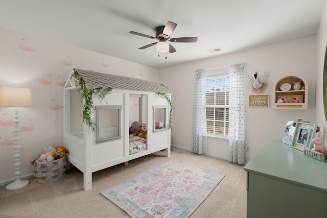 bedroom featuring light carpet and ceiling fan