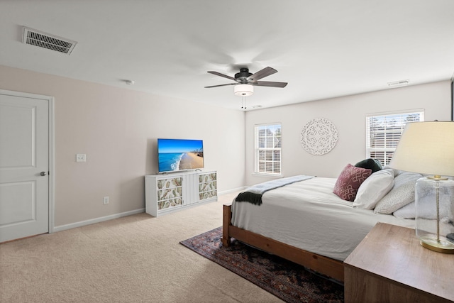 bedroom with ceiling fan and light colored carpet