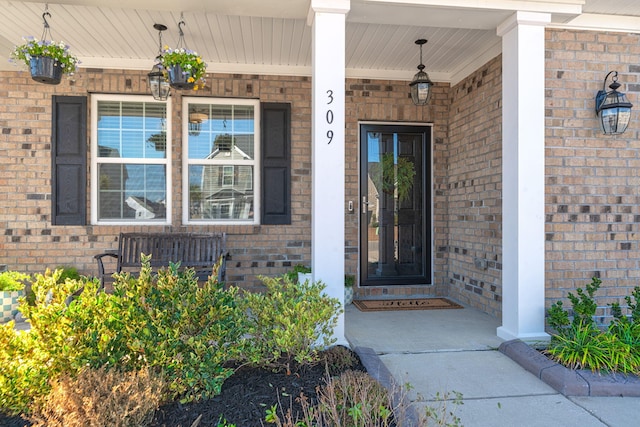 view of exterior entry with a porch