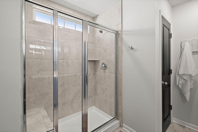 bathroom with a shower with shower door