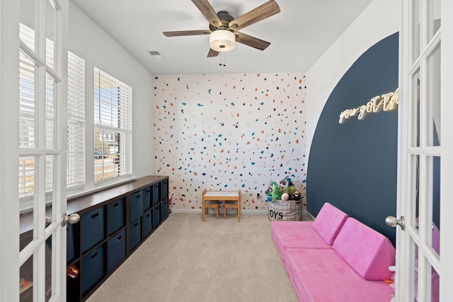 bedroom featuring ceiling fan, light colored carpet, and french doors