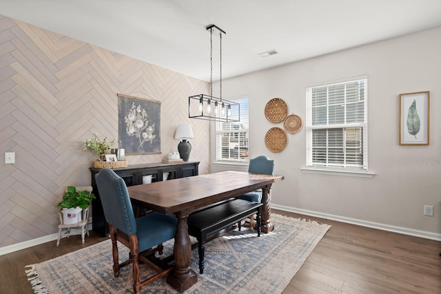 dining space featuring a chandelier and dark hardwood / wood-style flooring