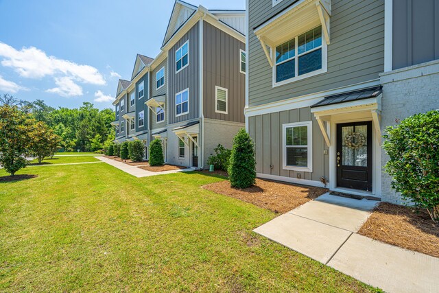 1242 Allusion Ln Unit 206, Mount Pleasant, SC 29466 - view of front of house with board and batten siding and a front yard