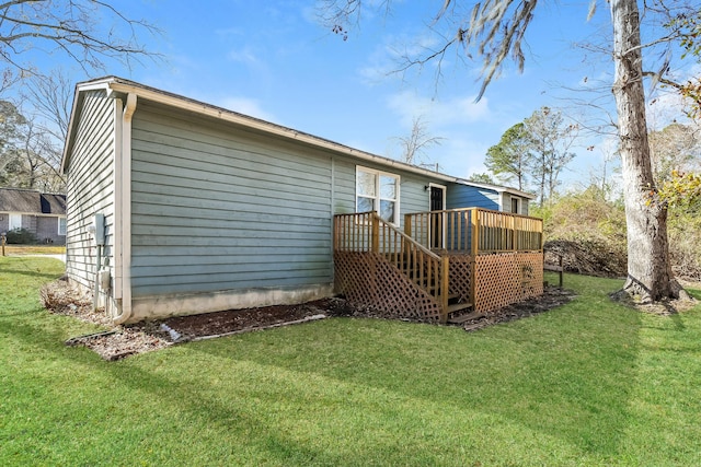 back of house with a yard and a deck