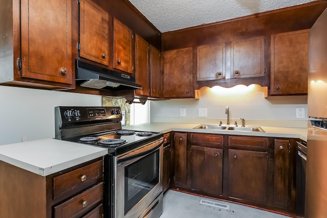 kitchen featuring electric range, sink, and a textured ceiling