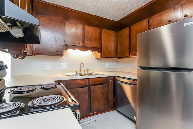 kitchen featuring sink, a textured ceiling, and appliances with stainless steel finishes