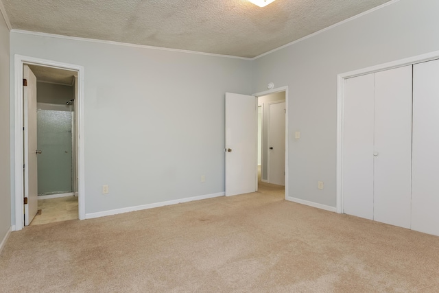 unfurnished bedroom featuring crown molding, a textured ceiling, light carpet, and a closet