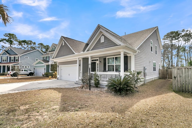 view of front of property with a garage, covered porch, fence, and concrete driveway