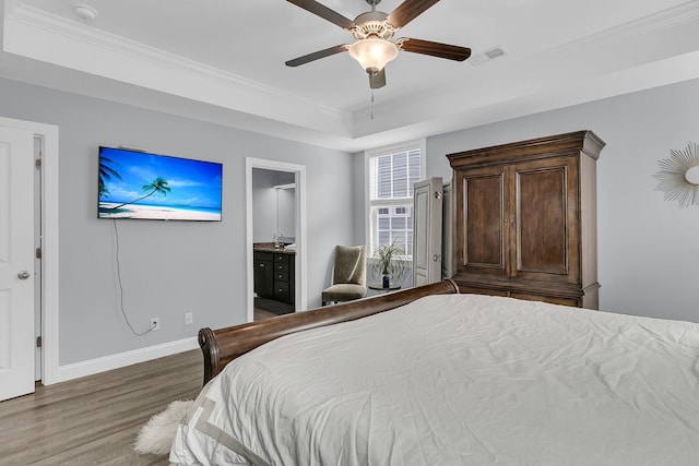 bedroom featuring visible vents, ornamental molding, a ceiling fan, wood finished floors, and baseboards