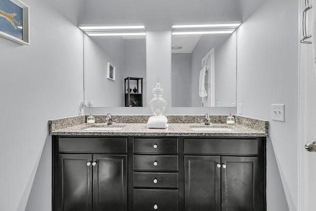 bathroom featuring a sink and double vanity