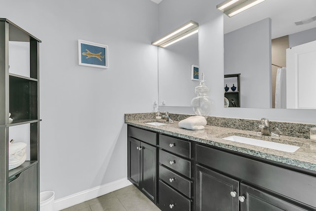 bathroom with tile patterned flooring, visible vents, a sink, and double vanity