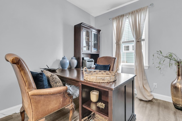 home office with wood finished floors and baseboards