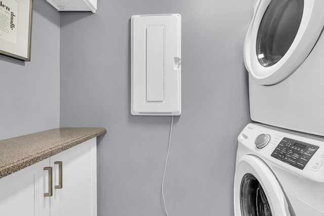 laundry area featuring laundry area and stacked washer / drying machine