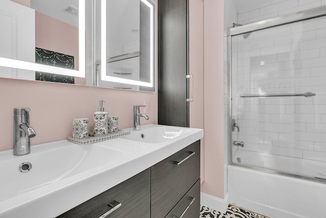 full bath featuring visible vents, bath / shower combo with glass door, and vanity