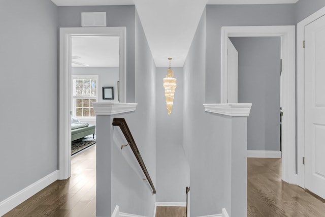 stairs featuring baseboards, visible vents, and wood finished floors