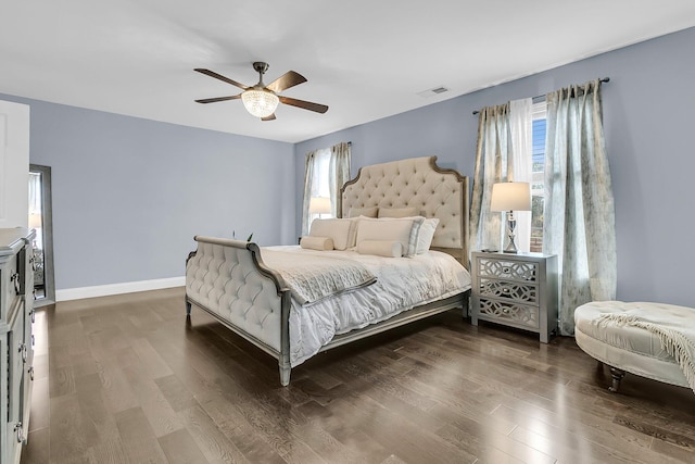 bedroom with a ceiling fan, baseboards, visible vents, and wood finished floors