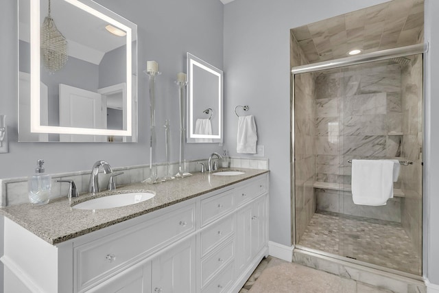 full bath featuring double vanity, a shower stall, and a sink