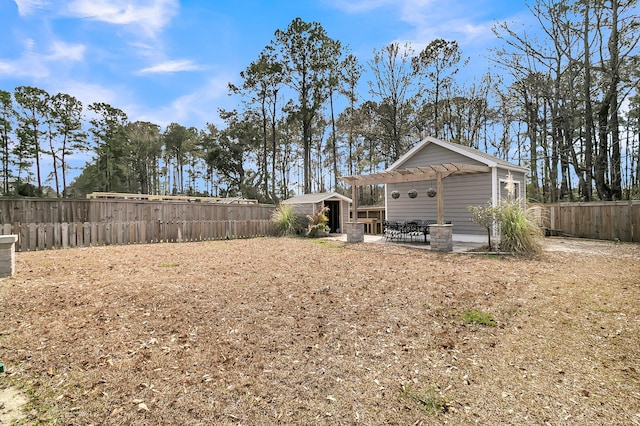 view of yard featuring an outbuilding, a fenced backyard, a patio, and a shed