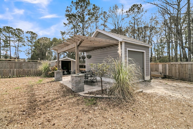 view of patio / terrace featuring a shed, an outdoor structure, a fenced backyard, and a pergola