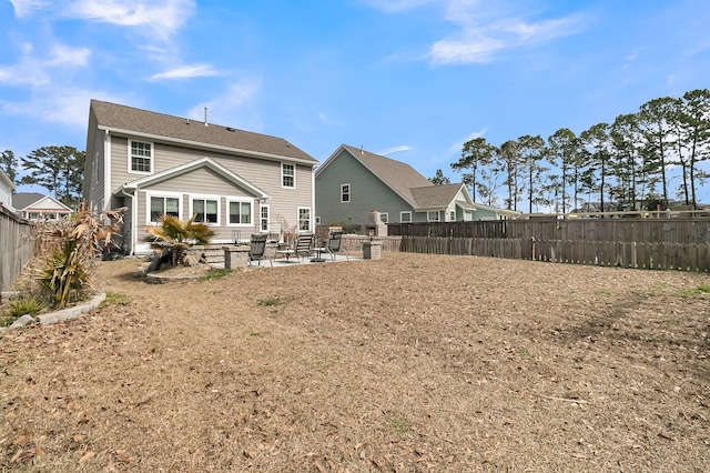 back of house with a patio and fence