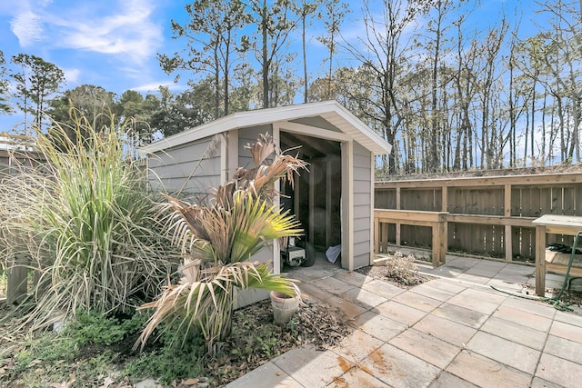 view of outbuilding with an outbuilding and fence