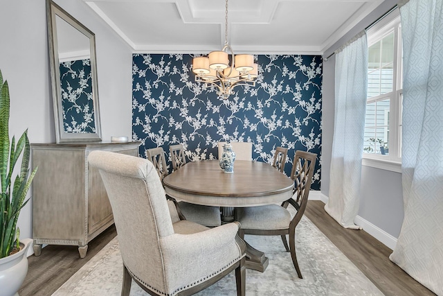 dining space featuring wallpapered walls, baseboards, and wood finished floors