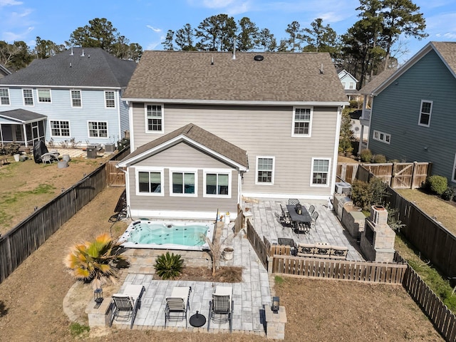 rear view of property with a patio area, a fenced backyard, and a jacuzzi