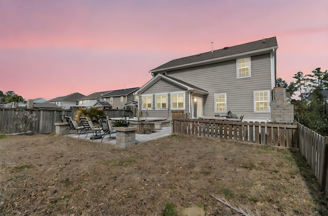 back of property featuring a patio and a fenced backyard