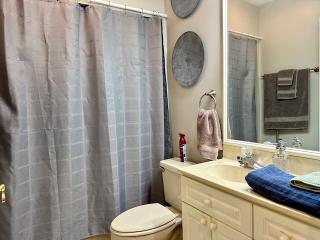 bathroom featuring toilet and vanity