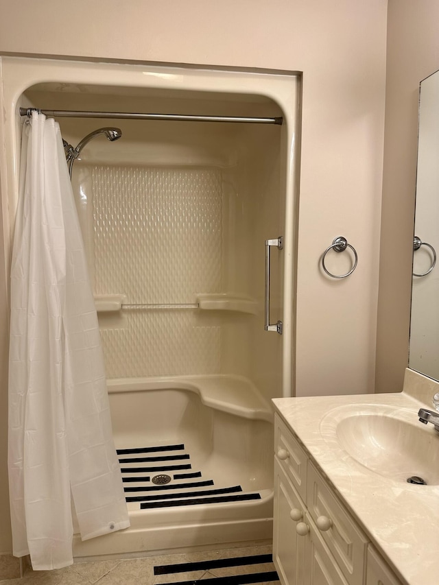 bathroom featuring a stall shower and vanity