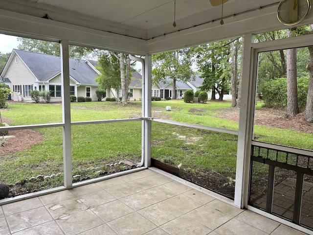 unfurnished sunroom featuring a residential view